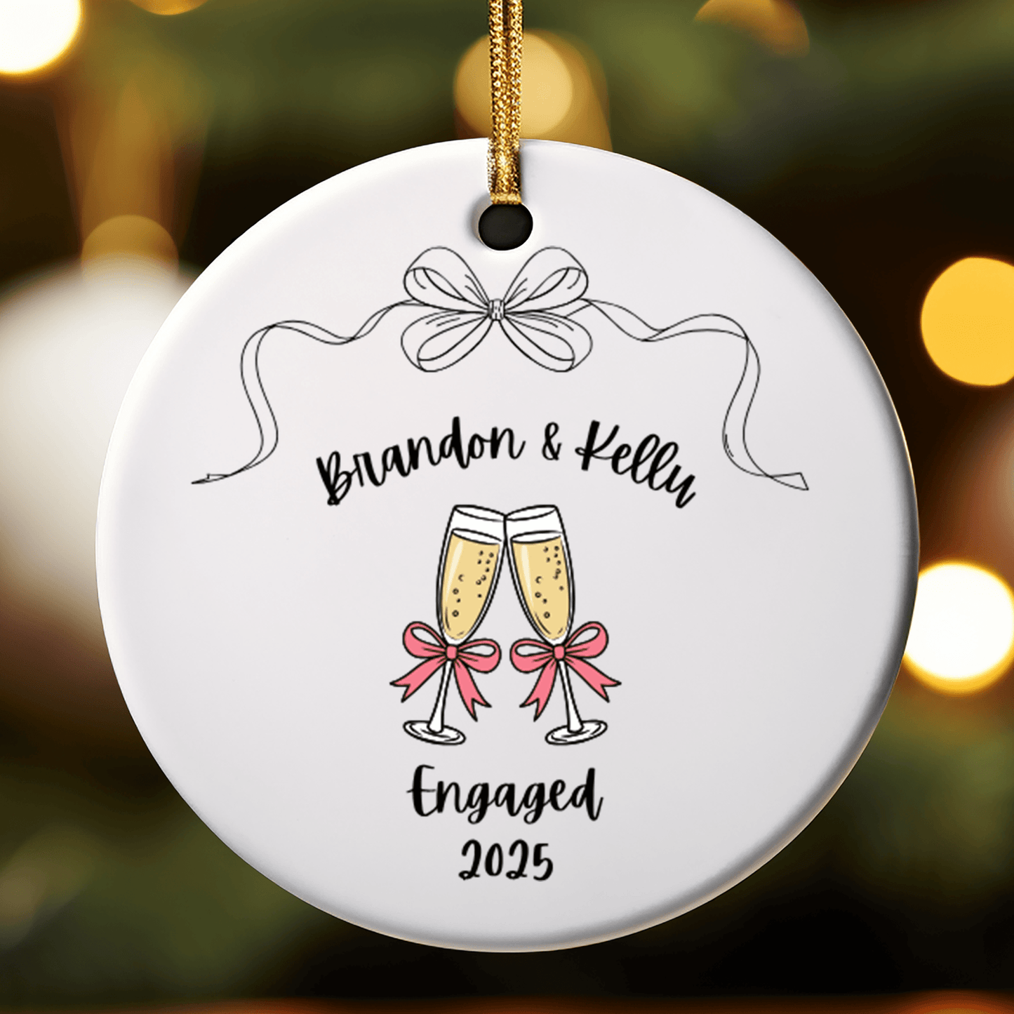 Round ceramic ornament with 'Brandon & Kelly Engaged 2025' text and champagne glasses on a blurred lights background.