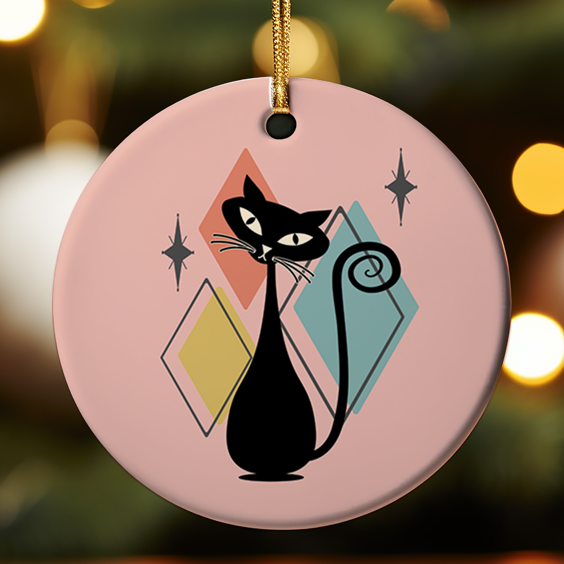 Decorative ornament with a black cat design on a pink background and diamonds in the background