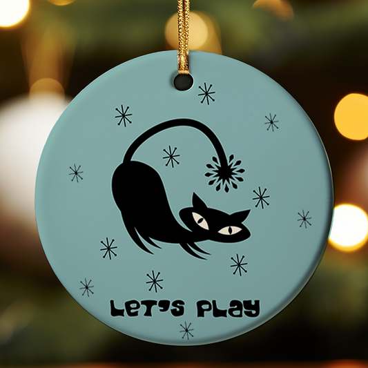 Decorative ornament with a black cat design and 'Let's Play' text on a light Teal background