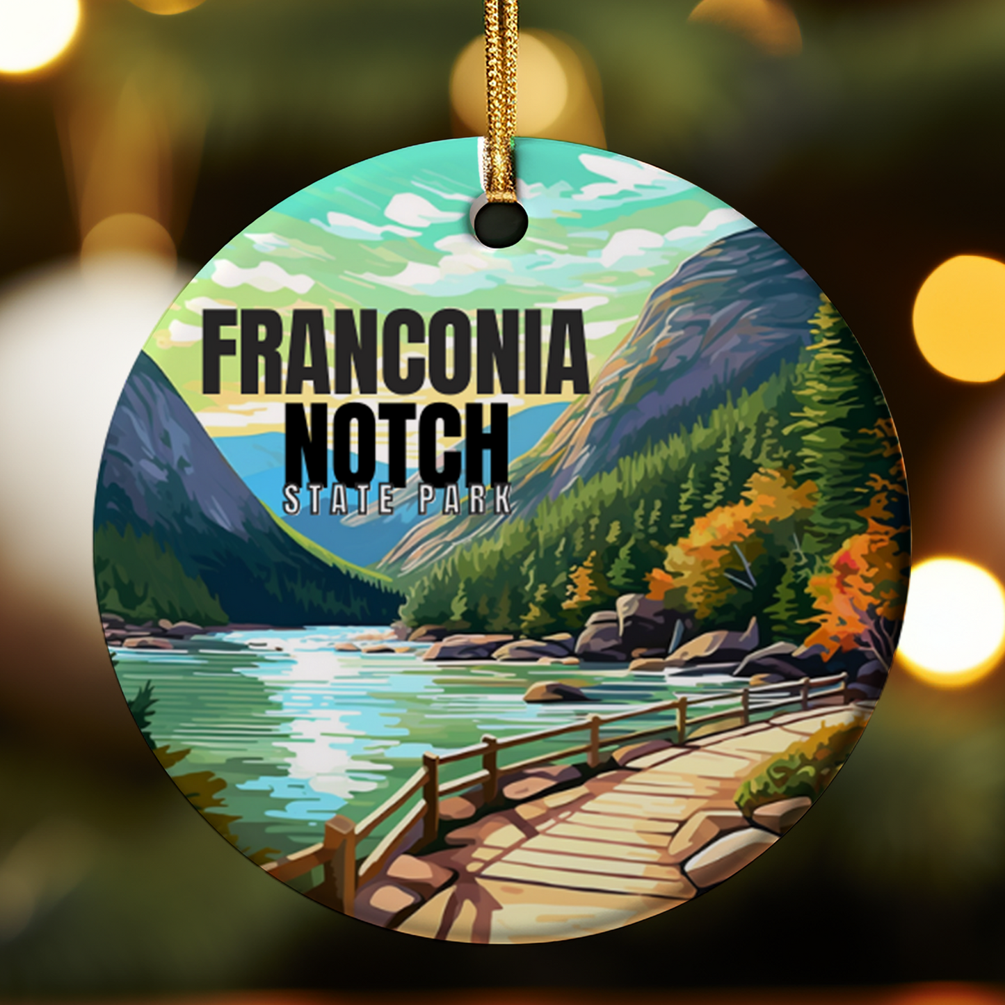 Circular ornament with Franconia Notch State Park design featuring a lake, mountains, and wooden bridge.