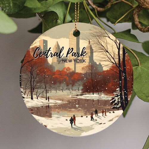 This holiday ornament displays an illustration of Central Park New York during a snowy day. The warm red falling tree leave create a picturesque scene looking onto the frozen reservoir along the winding path as snow flakes fall from the sky.