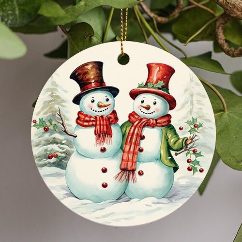 This holiday ornament shows two festive snow people with a welcoming embrace smiling on a snowy winter holiday morning.