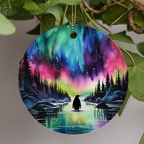 This holiday ornament shows the colorful Northern Lights. Pine trees scattered on the sides with snow cap mounds display an icy road. As a lone penguin admirers the nights starry colorful sky.