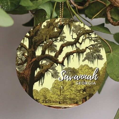 This on the ornamental image is of a live oak tree with hanging Spanish moss, and says Savannah Georgia on the front of the ornament.