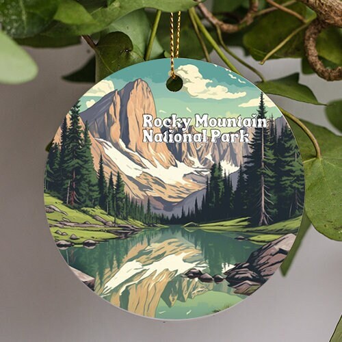 This ornament is of Rocky Mountain National Park in Colorado on a cool summers day, aspen trees back point high into the costal blue sky. The river reflects the off the the sky and mountains running through the still water of the illustration.