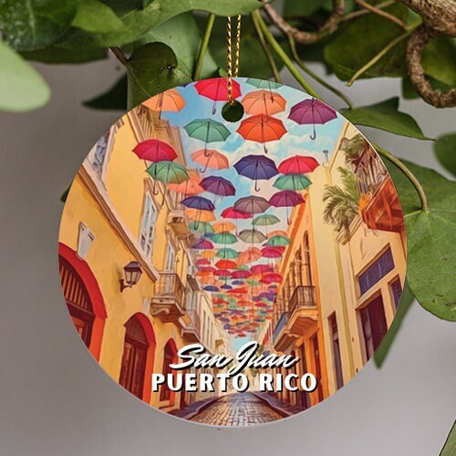 This holiday ornament displays the famous colorful parasols of Fortaleza Street in San Juan Puerto Rico. The warm building colors reminiscent of warm sandy beach as the cool blue sky provides the umbrellas a sense of floating.