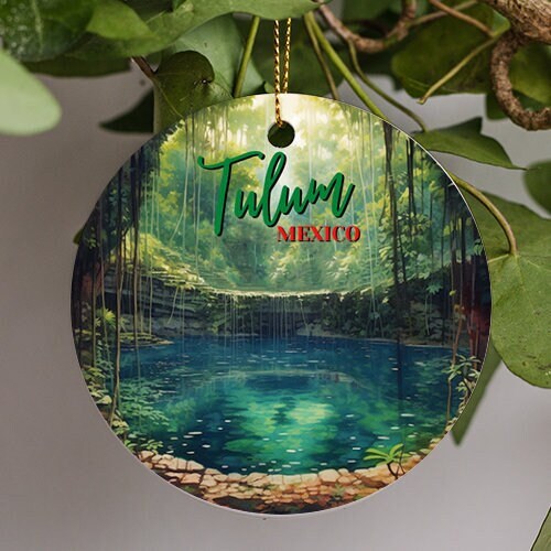 This ornament is a painting interpretation of the famous Cenote Zacil-ha in Tulum Mexico on a warm misty day lush full jungle trees line the cool reflective water  just through the caves opening during daylight.